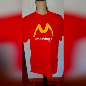 Red shirt I'm loving it Amsterdam.  Size medium.